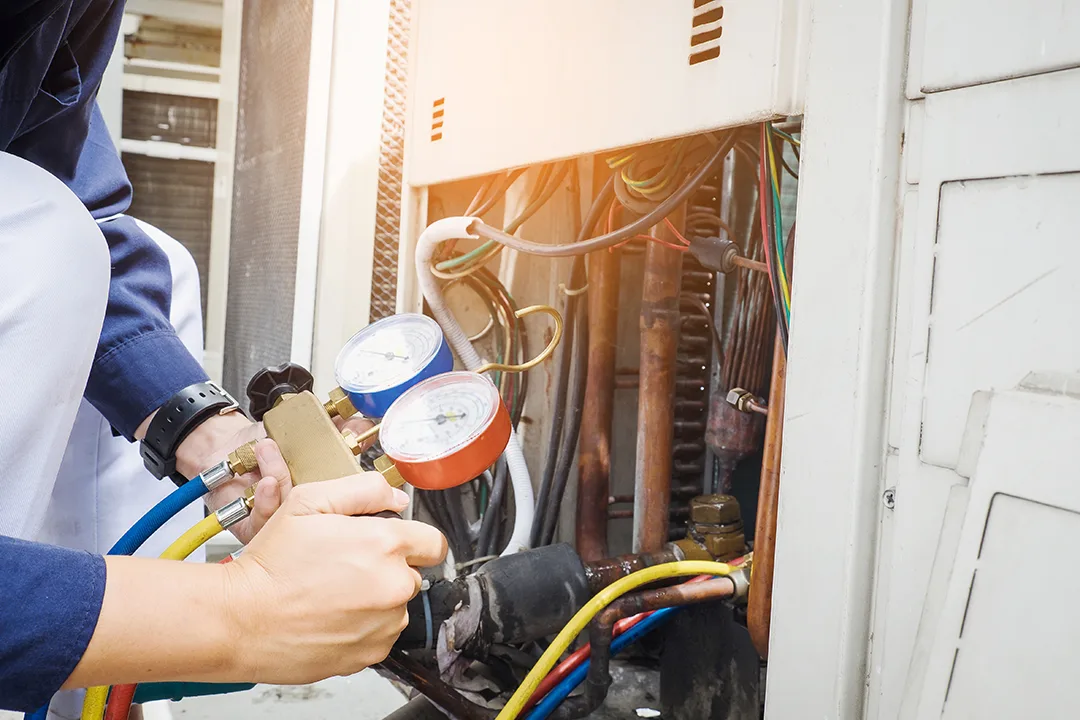 Technician is checking air conditioner in factory